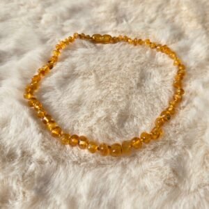 Collier bébé Ambre Miel AA sur fond neutre